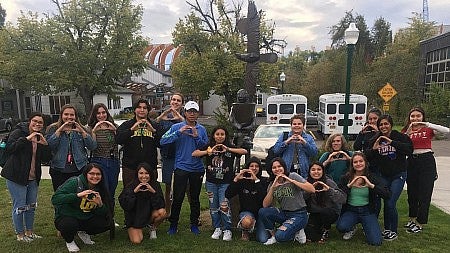 NAIS ARC 2019-20 cohort throwing their O's near the Rick Bartow Statue outside of Kalapuya Ilihi Hall
